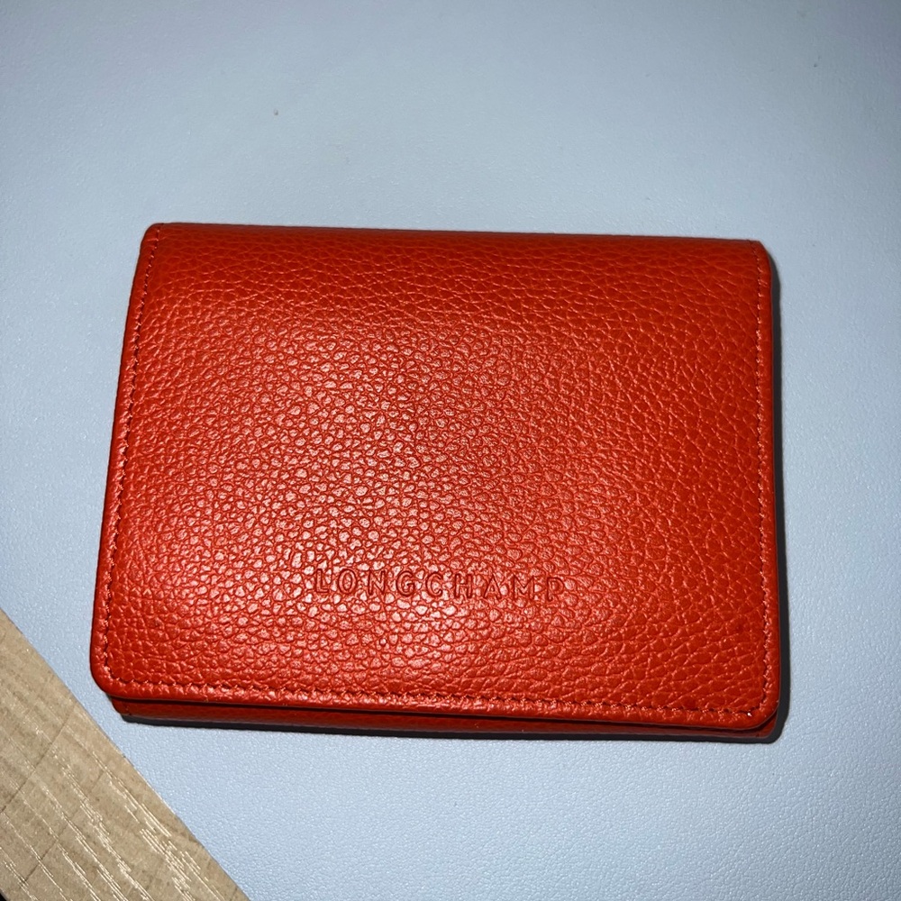Longchamp Orange Pebbled Leather compact wallet